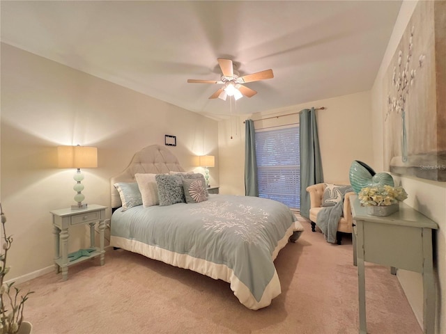 bedroom with light colored carpet, ceiling fan, and baseboards