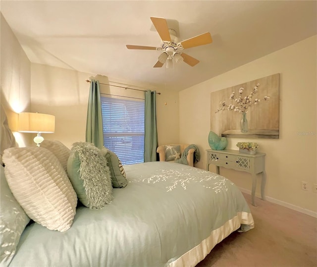 carpeted bedroom with baseboards and a ceiling fan