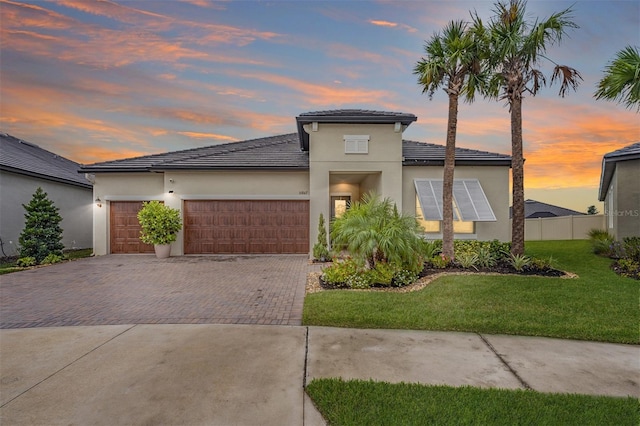 view of front of property with a lawn and a garage