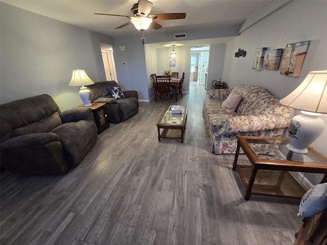 living room with hardwood / wood-style flooring and ceiling fan