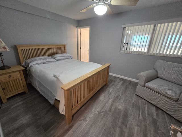 bedroom with dark hardwood / wood-style floors and ceiling fan