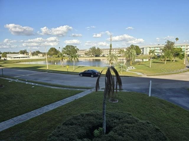 surrounding community featuring a yard and a water view