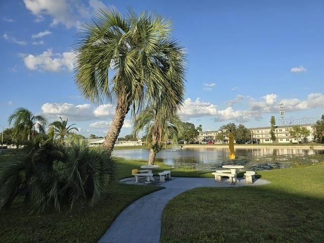 view of property's community with a water view and a yard