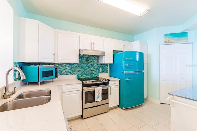 16500 Gulf Blvd Unit 352, North Redington Beach, FL 33708 - kitchen with stainless steel electric stove, a sink, under cabinet range hood, white cabinetry, and light countertops