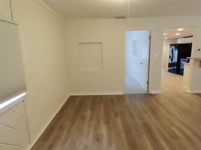 empty room with light hardwood / wood-style floors