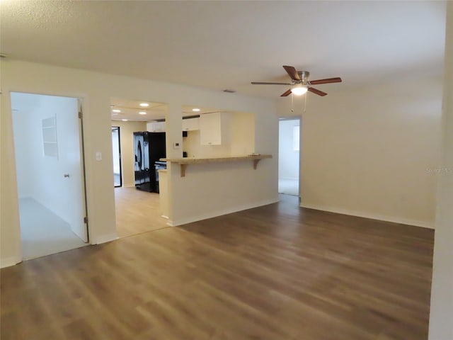 unfurnished living room with ceiling fan and light wood-type flooring