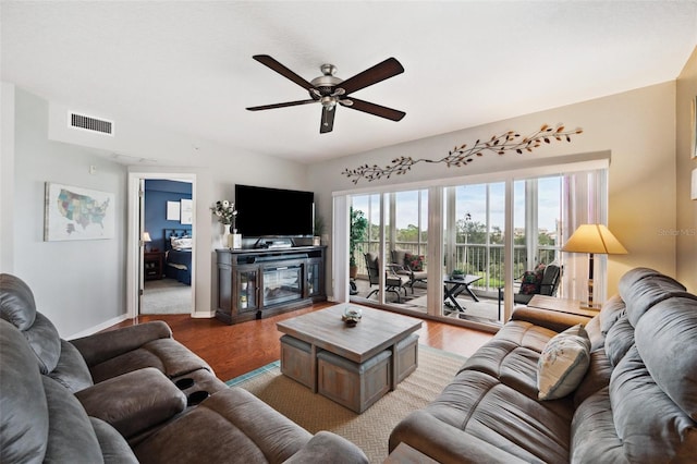 living room featuring ceiling fan and wood-type flooring