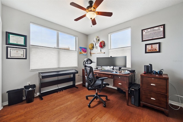 home office featuring hardwood / wood-style flooring, ceiling fan, and plenty of natural light