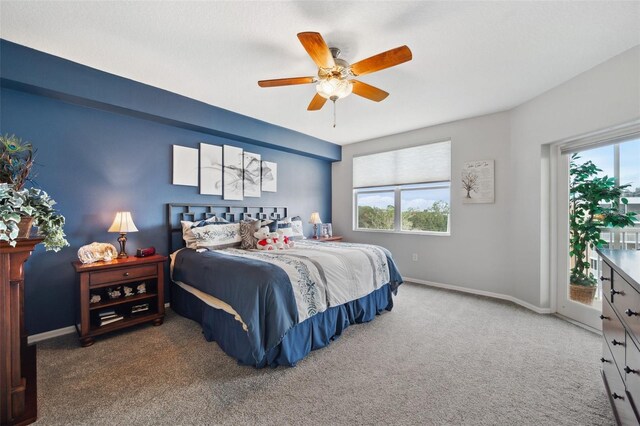 bedroom featuring access to outside, carpet floors, multiple windows, and ceiling fan