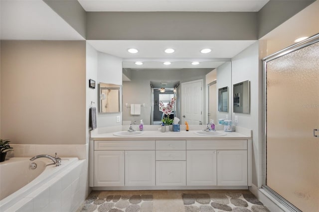 bathroom featuring independent shower and bath, ceiling fan, and vanity