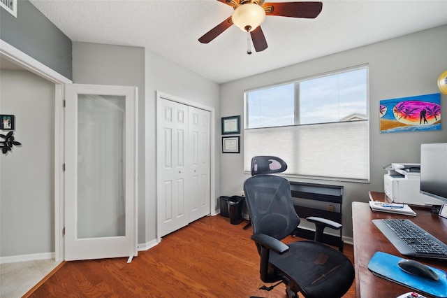 office with hardwood / wood-style floors, ceiling fan, and a textured ceiling