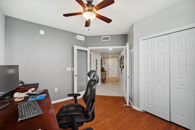 office with hardwood / wood-style floors and ceiling fan