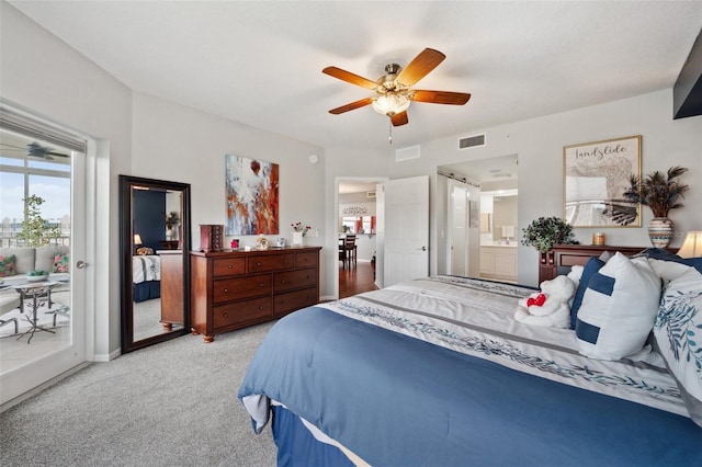 carpeted bedroom featuring access to outside, ceiling fan, and connected bathroom