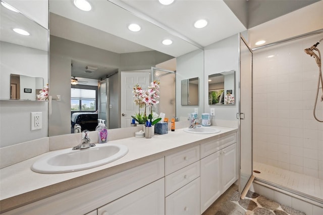 bathroom featuring ceiling fan, vanity, and tiled shower