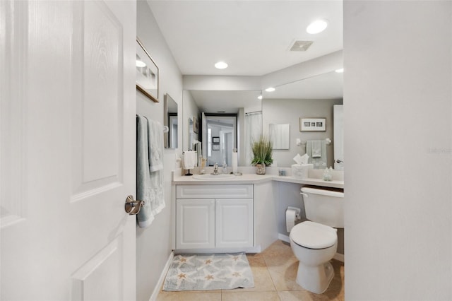 bathroom featuring tile patterned flooring, vanity, and toilet