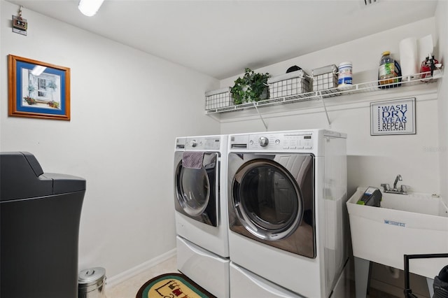 laundry room featuring washing machine and dryer and sink