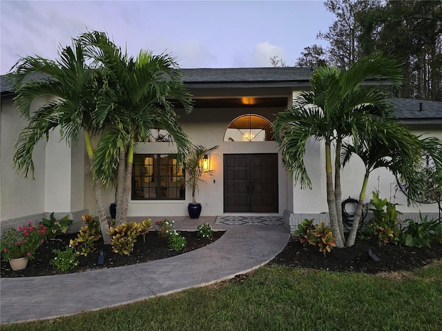 view of exterior entry at dusk