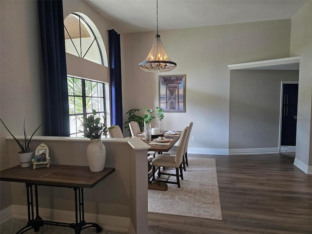 dining area with an inviting chandelier and dark wood-type flooring