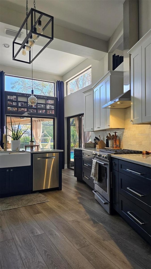 kitchen featuring stainless steel appliances, hanging light fixtures, dark hardwood / wood-style floors, and white cabinets