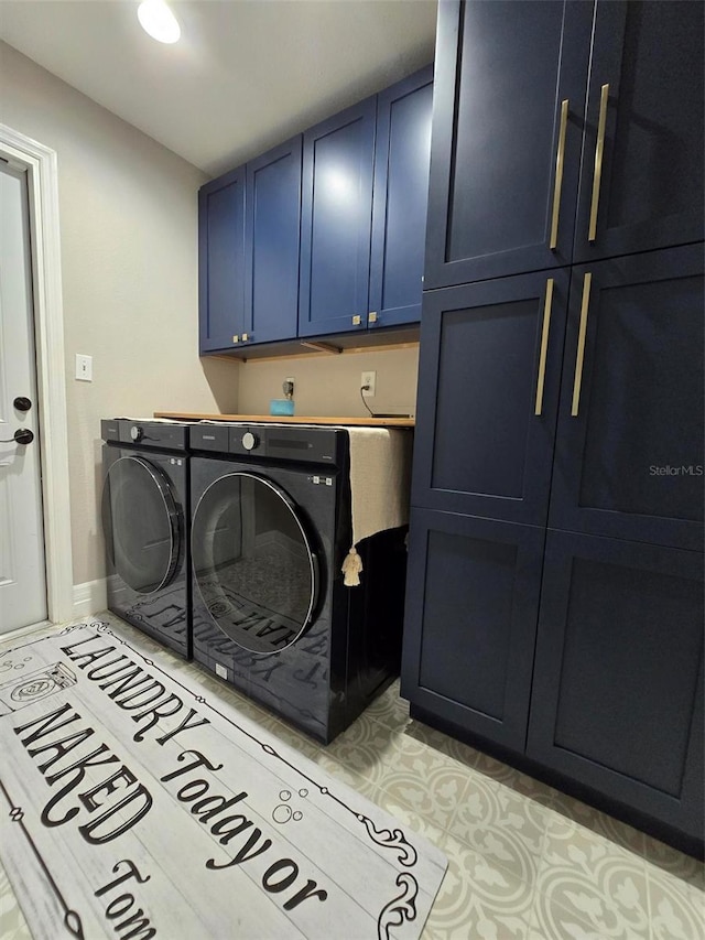 laundry area featuring light tile patterned flooring, cabinets, and separate washer and dryer