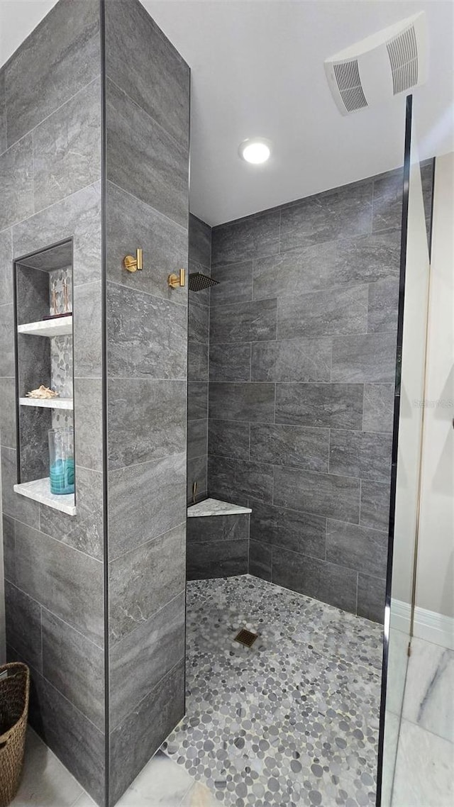 bathroom with tiled shower