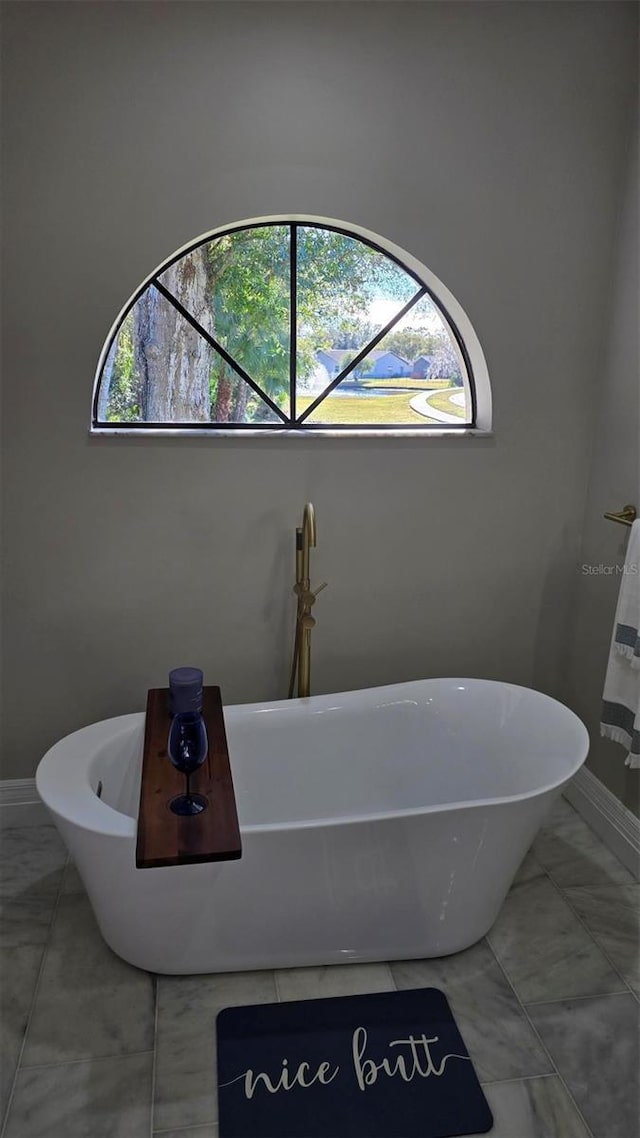 bathroom featuring a tub to relax in