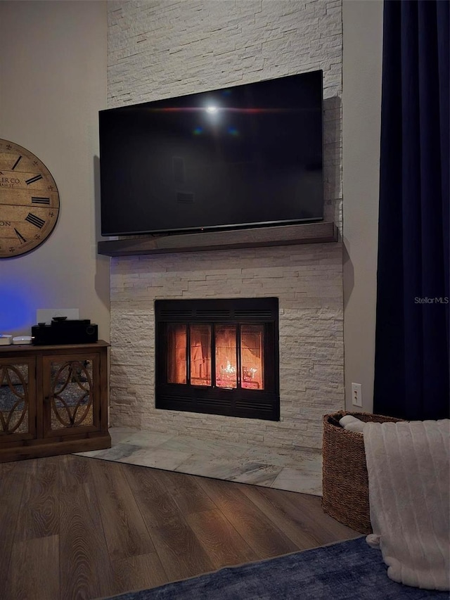 interior details featuring hardwood / wood-style flooring and a fireplace