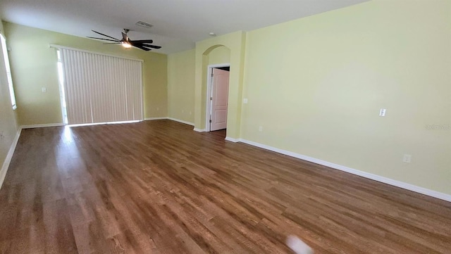 unfurnished room featuring dark hardwood / wood-style floors and ceiling fan