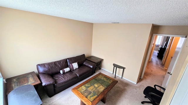 carpeted living room with a textured ceiling