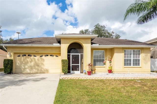 view of front of house with a garage and a front lawn