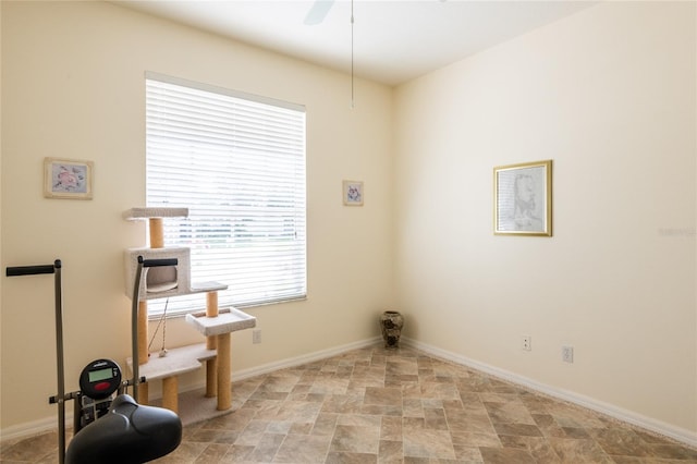 24617 Laurel Ridge Dr, Lutz, FL 33559 - unfurnished room with stone finish floors, baseboards, and ceiling fan