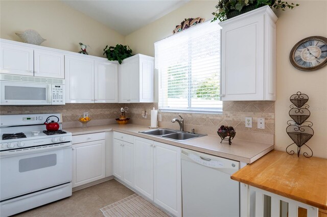 24617 Laurel Ridge Dr, Lutz, FL 33559 - kitchen featuring white appliances, a sink, tasteful backsplash, light countertops, and white cabinets