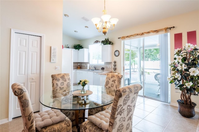 tiled dining area featuring a chandelier and sink