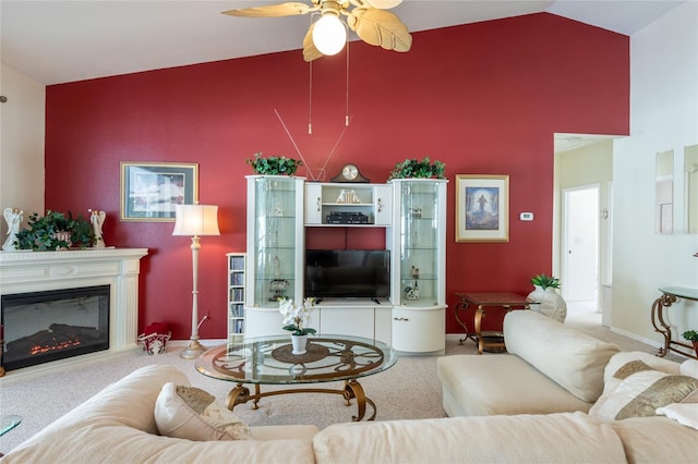 24617 Laurel Ridge Dr, Lutz, FL 33559 - living area featuring high vaulted ceiling, carpet flooring, a ceiling fan, a glass covered fireplace, and baseboards