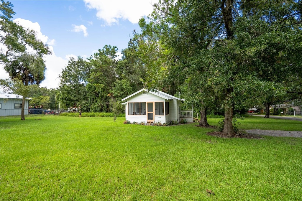 view of yard featuring a sunroom