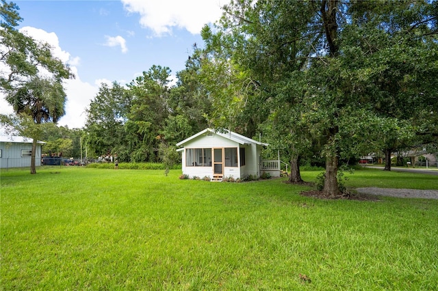 view of yard featuring a sunroom