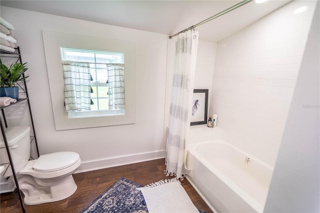 bathroom featuring hardwood / wood-style floors, toilet, shower / bathtub combination with curtain, and vaulted ceiling