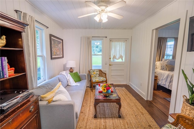 sitting room featuring plenty of natural light, dark hardwood / wood-style floors, wood ceiling, and ceiling fan