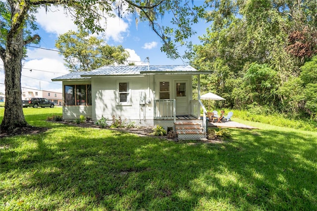 rear view of property with a lawn