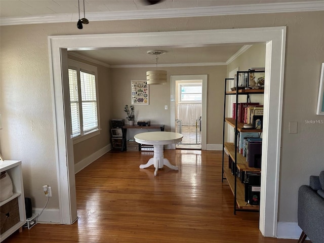 dining space featuring hardwood / wood-style flooring and ornamental molding