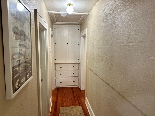 hall featuring a textured ceiling and dark hardwood / wood-style floors