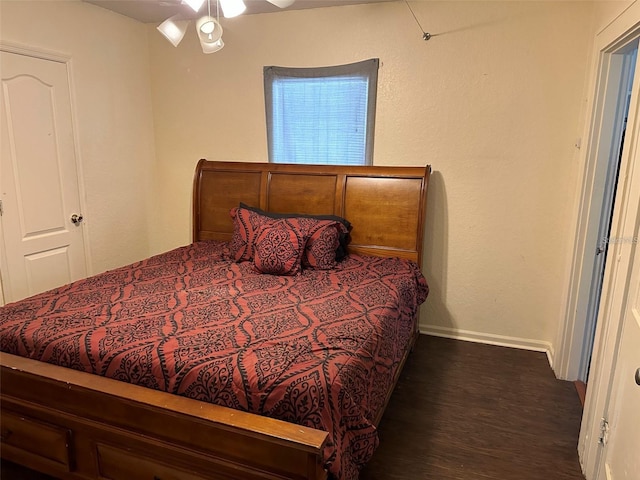 bedroom with dark wood-type flooring and ceiling fan