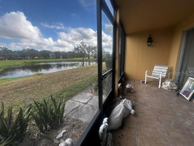 sunroom / solarium with a water view