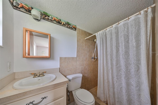 bathroom with a shower with shower curtain, a textured ceiling, vanity, toilet, and tile walls