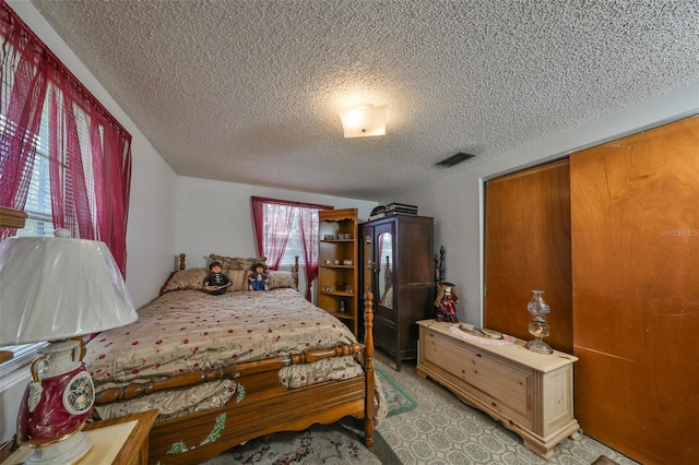 carpeted bedroom featuring a closet and a textured ceiling