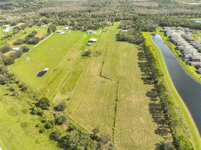 drone / aerial view with a water view and a rural view