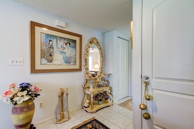 doorway featuring a textured ceiling and light tile patterned floors