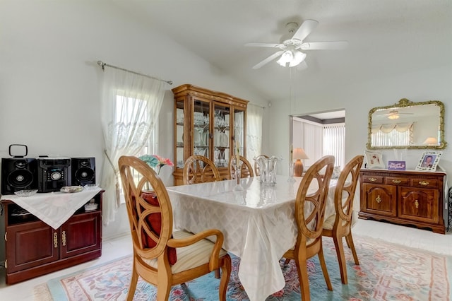 dining space with vaulted ceiling, light tile patterned flooring, and ceiling fan