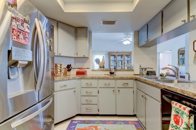 kitchen featuring black dishwasher, sink, ceiling fan, decorative backsplash, and stainless steel fridge with ice dispenser