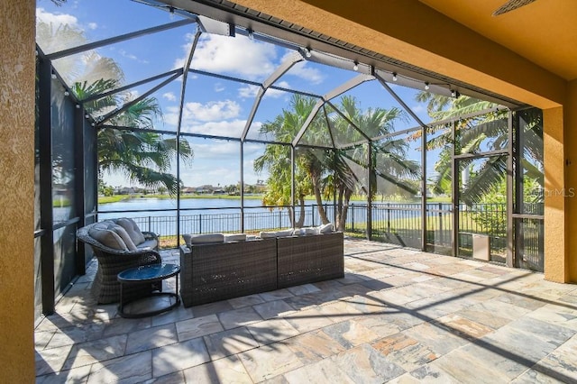 view of patio / terrace with outdoor lounge area, a water view, and a lanai